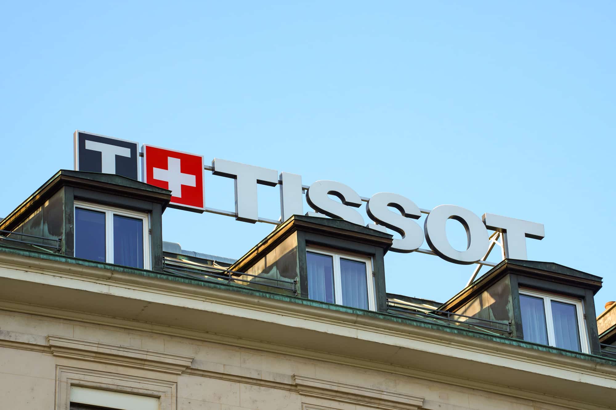 Large ground-mounted illuminated sign ready for installation on a roof in Geneva