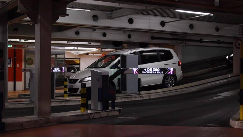 Digital advertising displays placed on the automatic barriers of Manor Parking in Vevey, ensuring strong and connected visibility