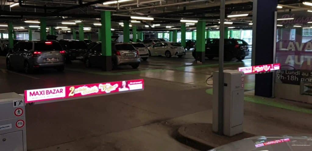 Digital advertising panels installed on the barrier arms of Centre Blandonnet Parking in Geneva, providing modern and impactful visibility.