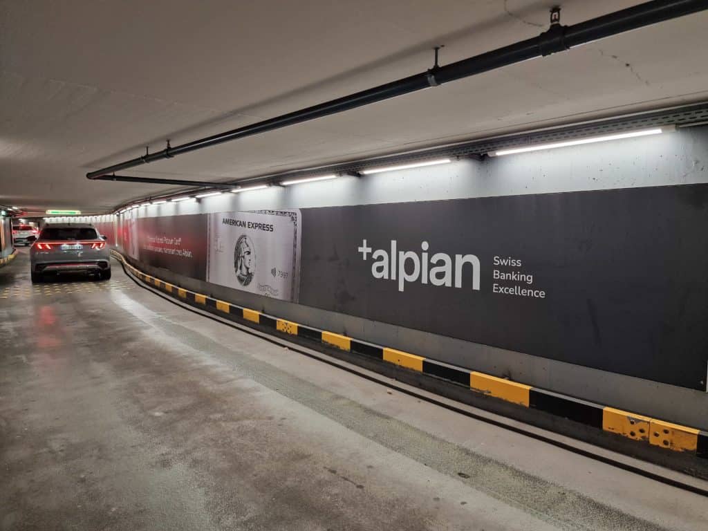 Alpian advertising megaposter displayed at the Left Bank entrance of the Mont-Blanc Car Park in Geneva, visible to motorists using this entrance.