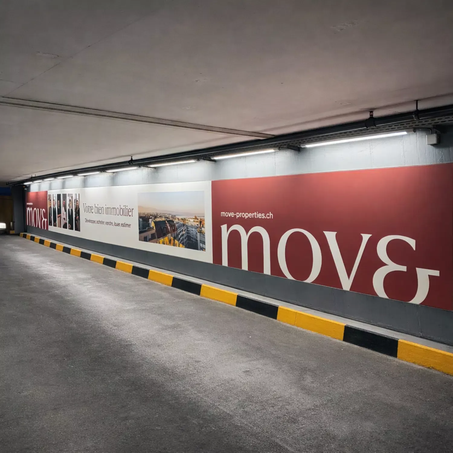 Large Moser Vernet & Cie megaposter installed on the right-hand wall at the Rive Gauche exit of the Mont-Blanc car park in Geneva, tensioned canvas backlit by LED, visible along the vehicle traffic lane.